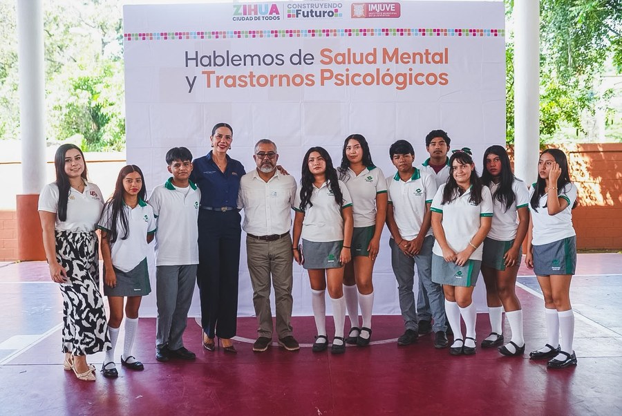 Grupo de estudiantes y autoridades frente a la lona Hablemos de Salud Mental y Trastornos Psicológicos en Zihuatanejo